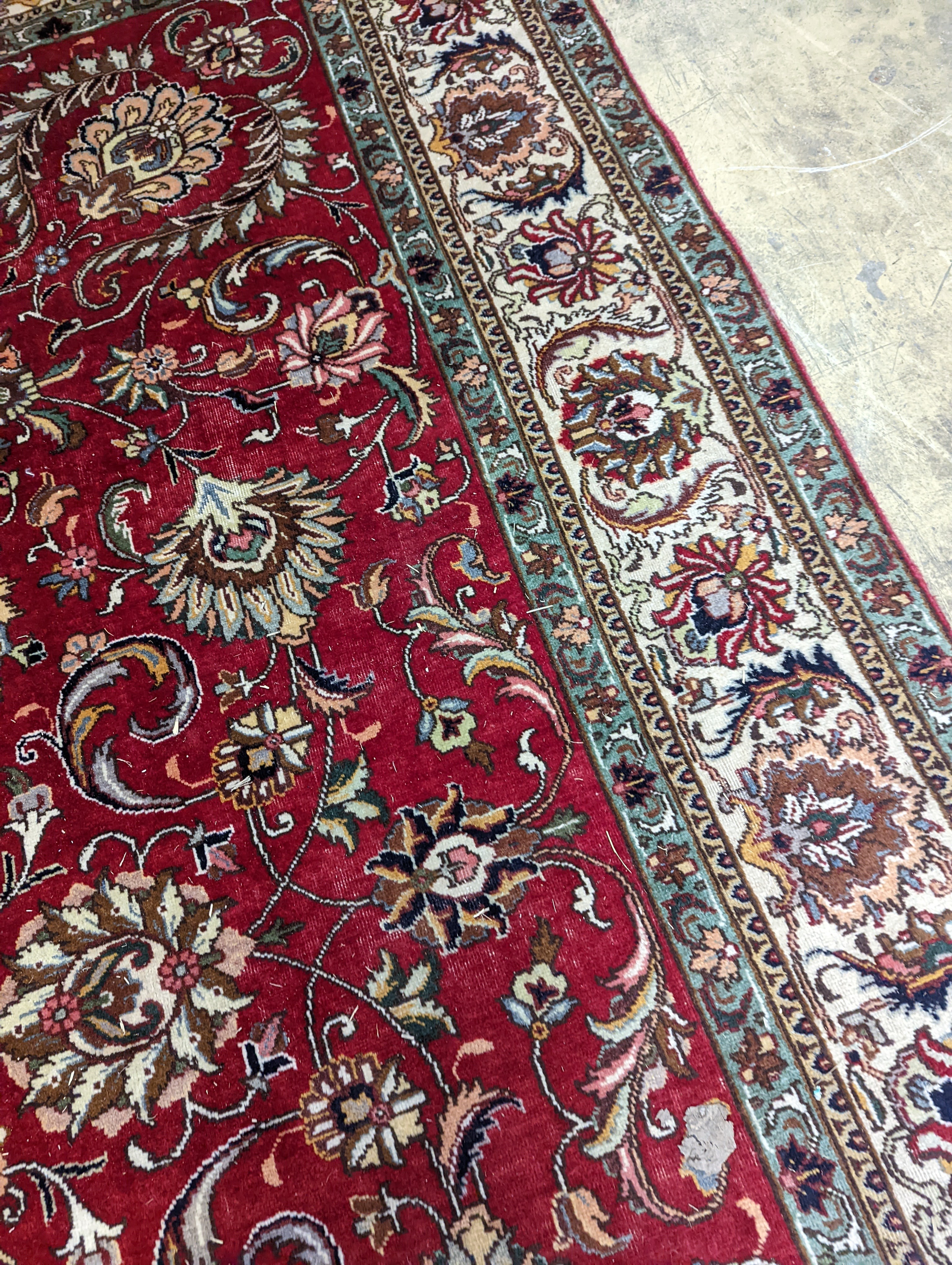 A Tabriz red ground carpet, 400 x 290cm